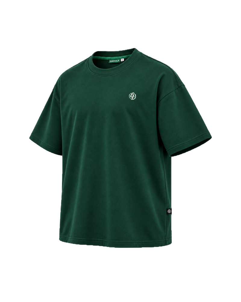 Forest green Ghoolf mock neck tee, three-quarter view, with ivory signet on the chest and woven tab at the side seam