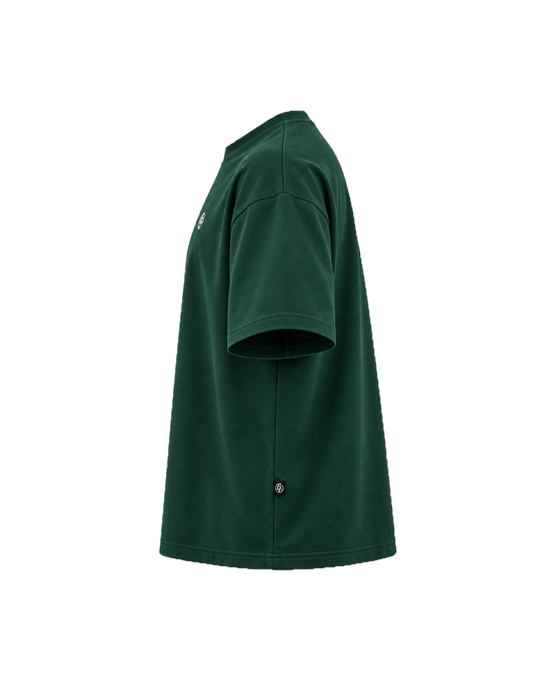 Forest green Ghoolf mock neck tee, side view, with dropped shoulder and woven tab at the side seam