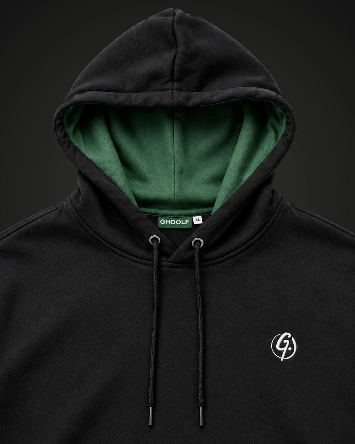 Forest green hood lining, neck label and embroidered signet on the black pullover hoodie