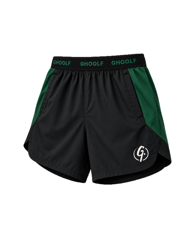 Black Ghoolf sport shorts with forest green side panels, three-quarter view, with split curved hem