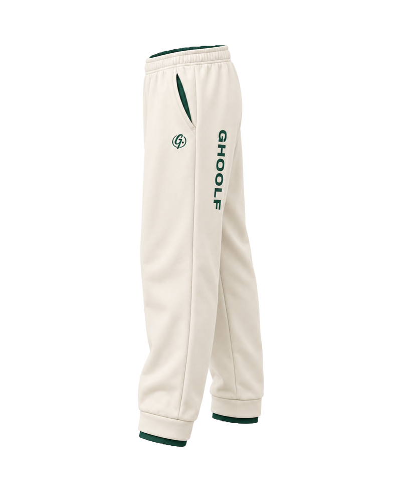 Ivory Ghoolf sweatpants, side view, with forest green Ghoolf wordmark down the leg